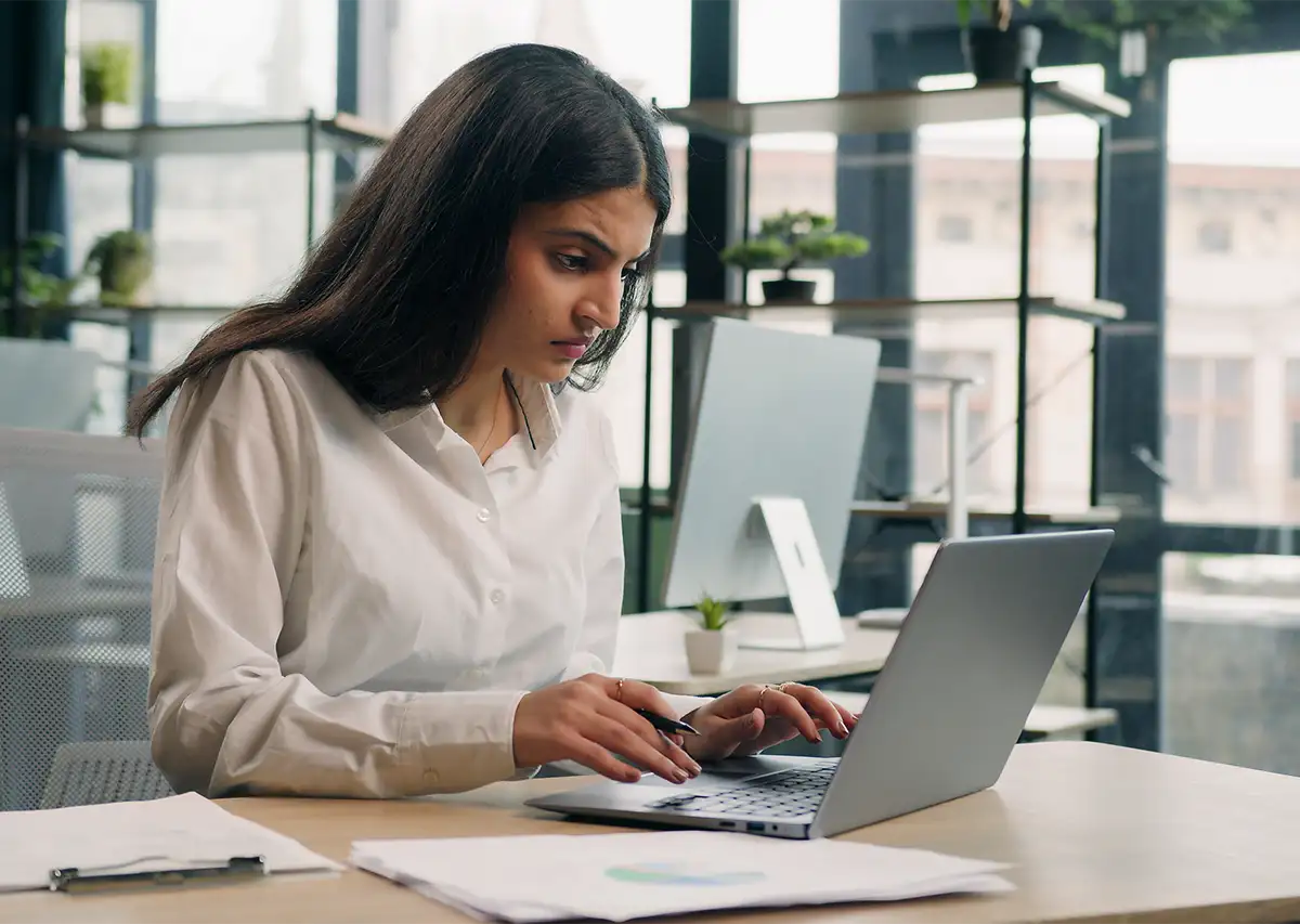 Young stressed businesswoman working on computer
