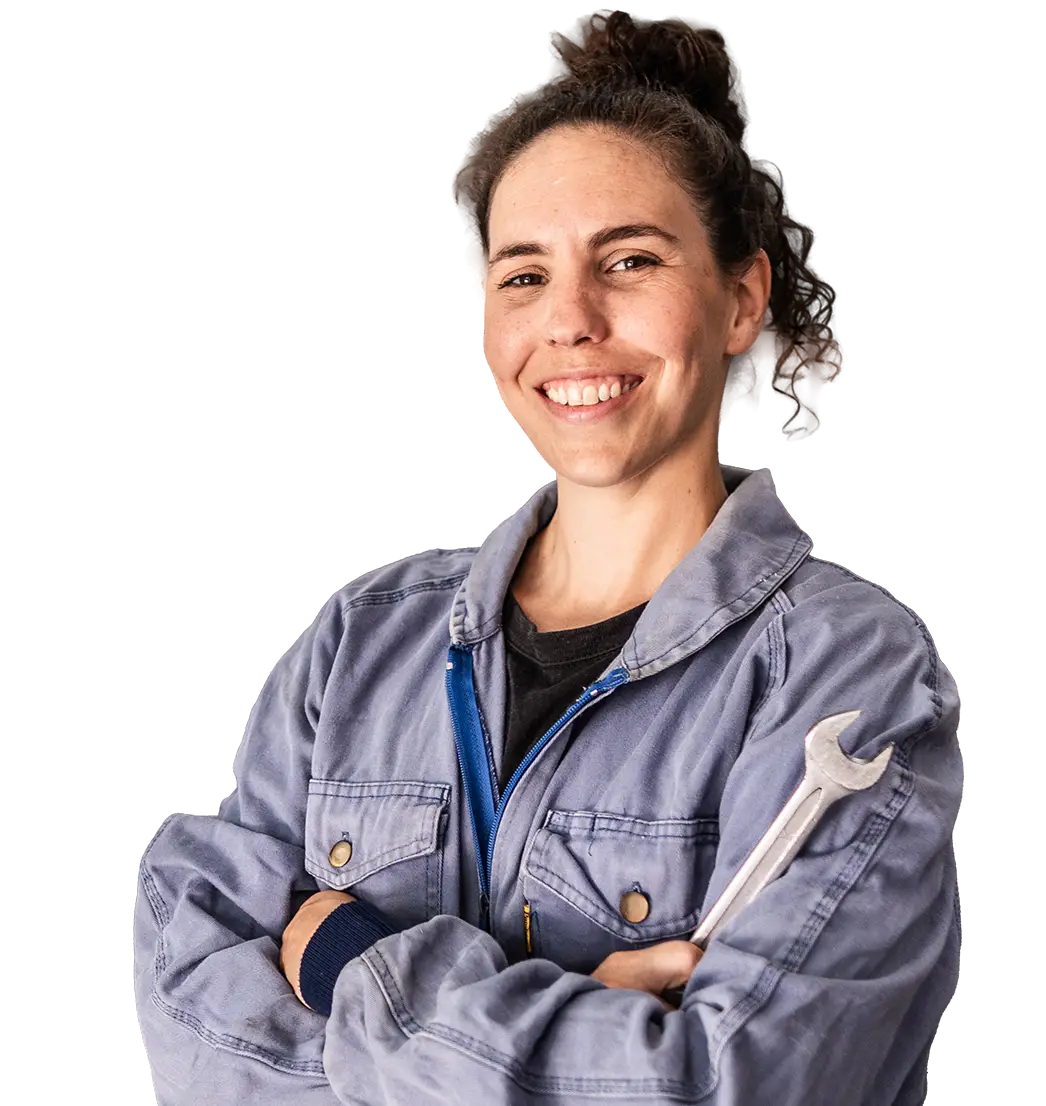 Auto mechanic wearing coveralls and holding wrench