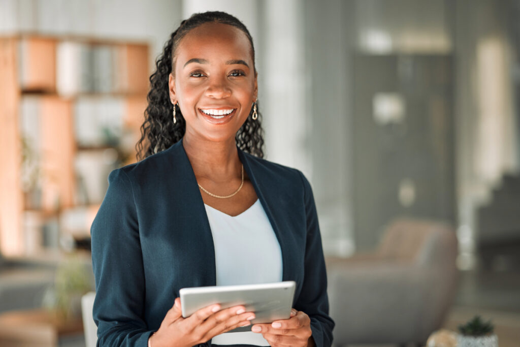 Professional holding a tablet in her office