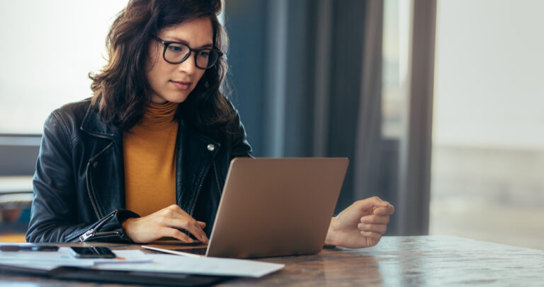 Asian woman working at laptop