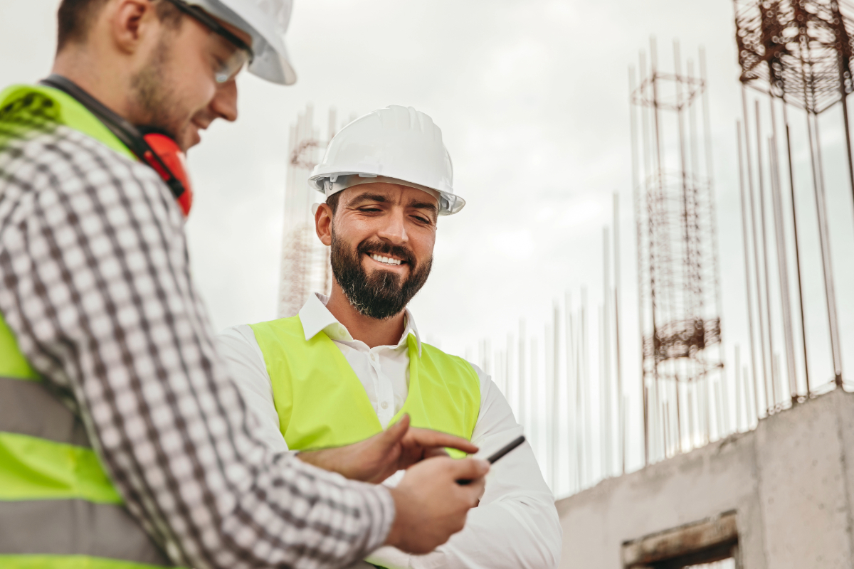 Construction workers looking at a mobile phone