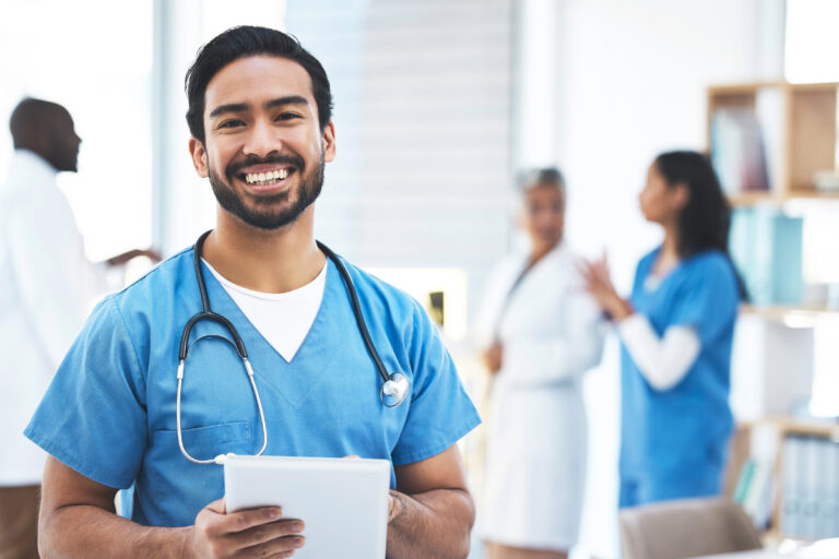 Doctor in scrubs holding tablet