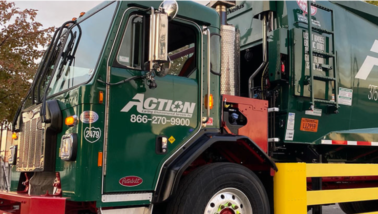 Close up of a green recycling truck