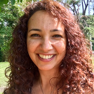 Woman smiling with outdoor background