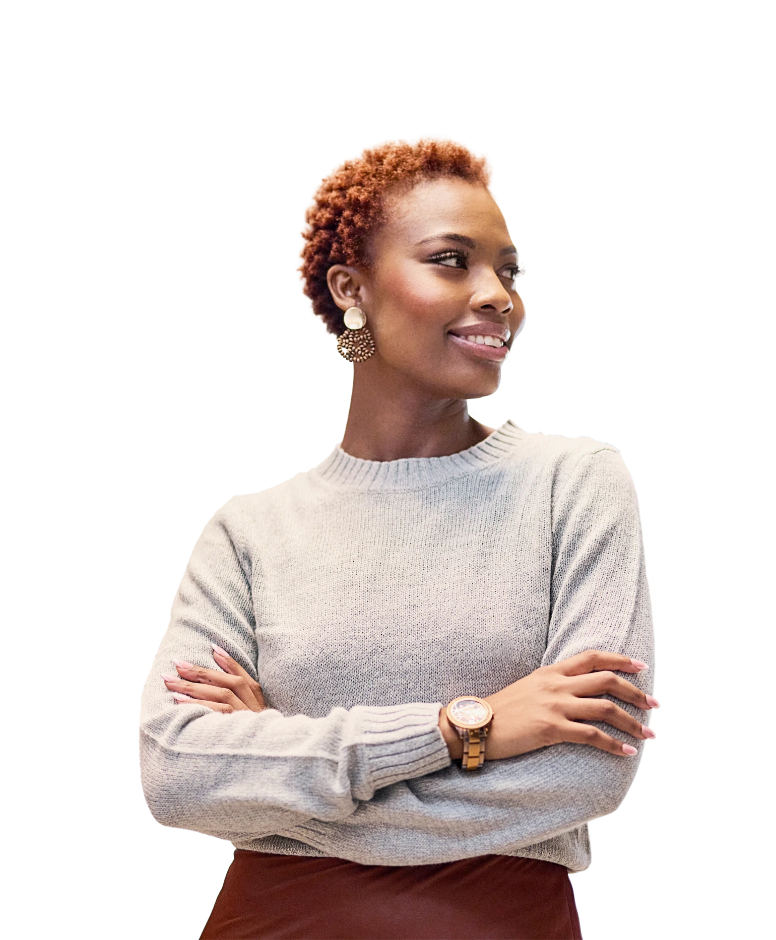 A woman with her arms crossed, smiling, looking to her left