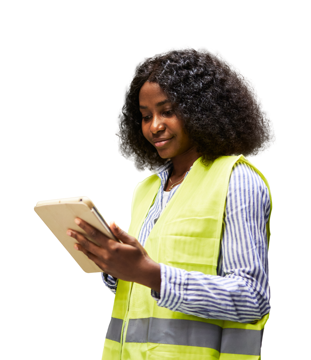 A worker in a safety vest consults a tablet