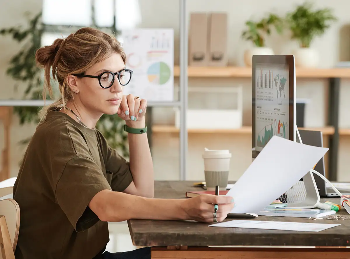 Young professional woman looking at invoice