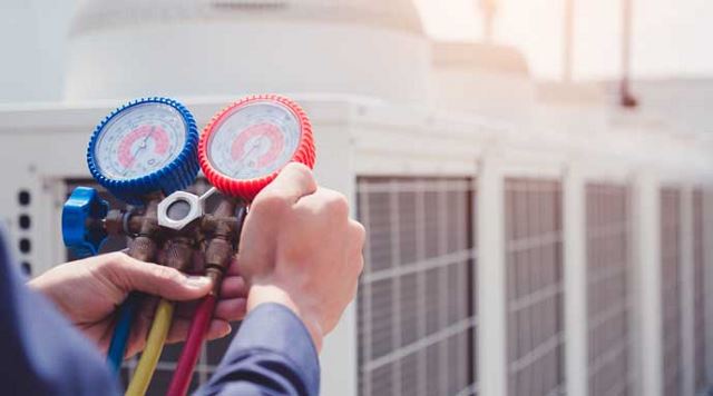 hands holding pressure gauges