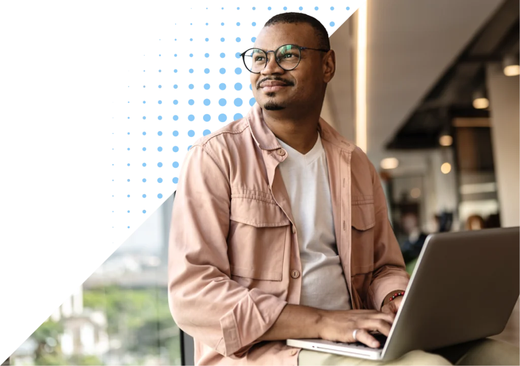 man sitting with laptop on lap