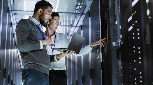 professionals looking at IT equipment