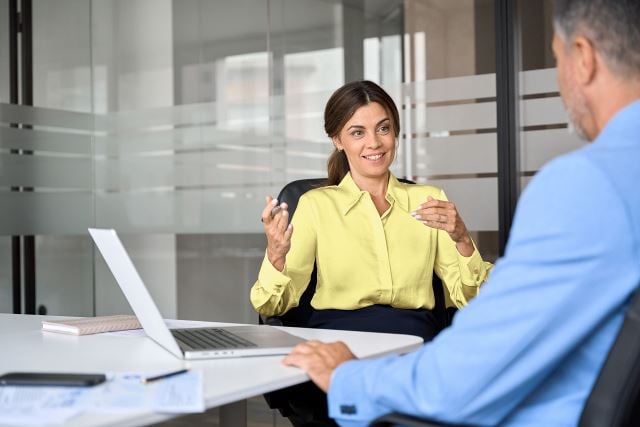 ey study featuring a woman at a conference table with a co-worker