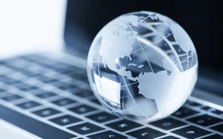 frosted glass globe sitting on laptop keyboard