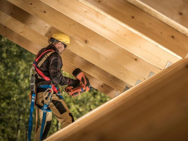 Carpenter building a roof