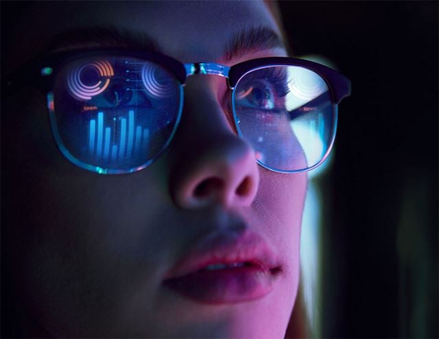 Woman's Face with Bar Graph Reflecting in Glasses