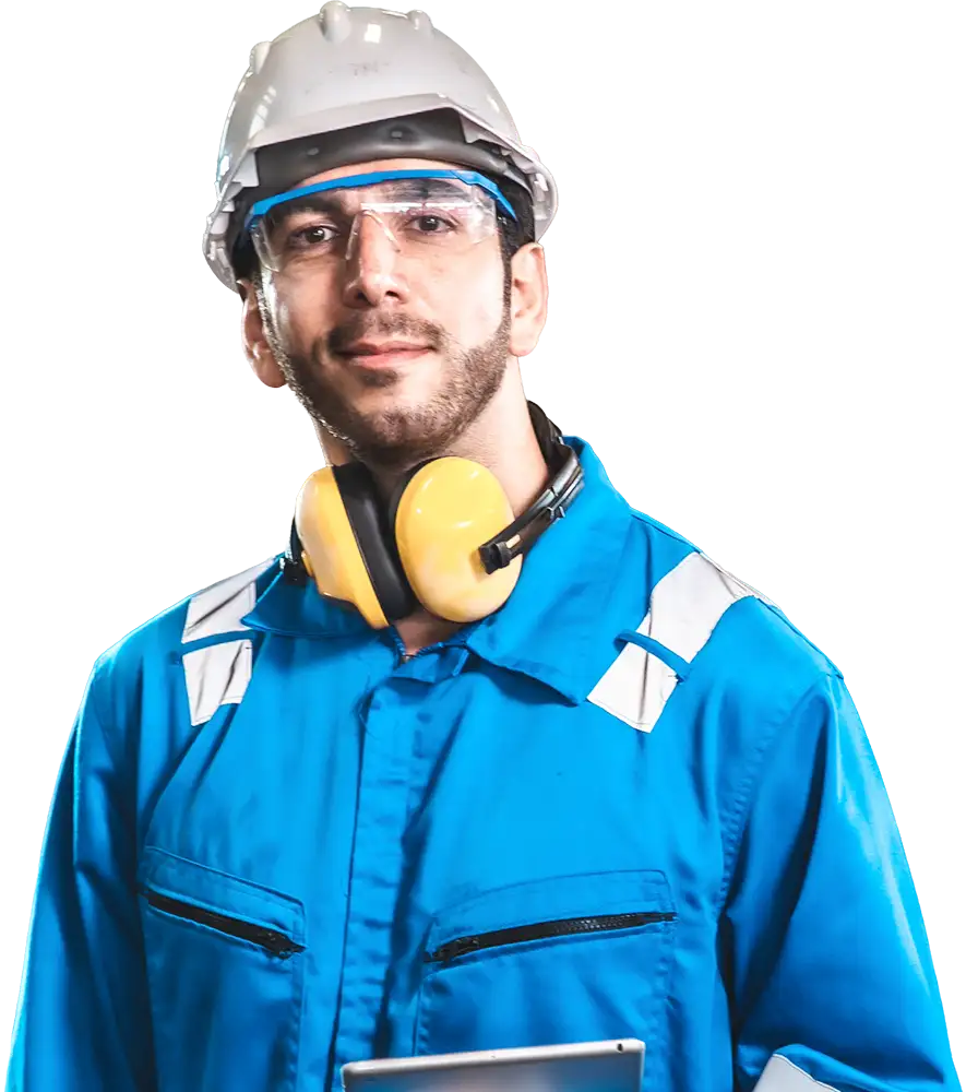 Worker in coveralls with head eye and ear protection