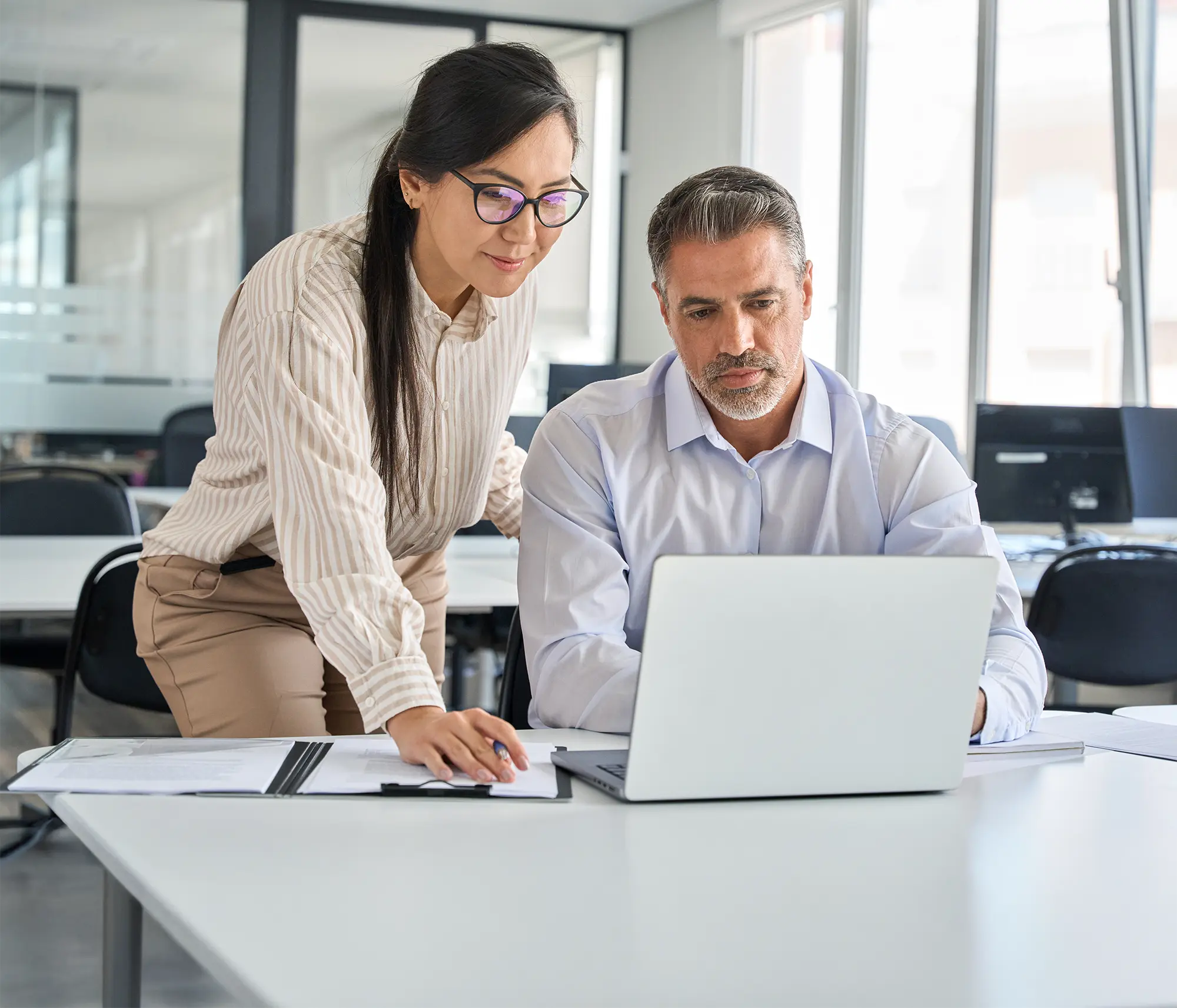 man and woman looking at computer together
