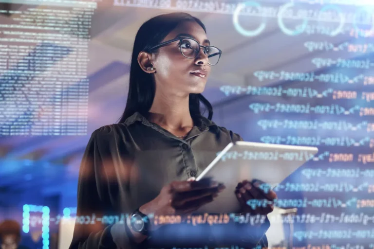 woman holding tablet looking at code