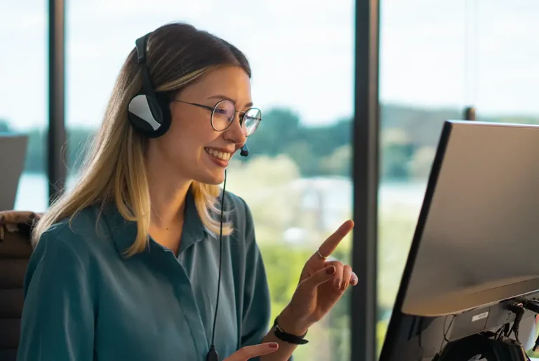 Woman working in call center assisting customers wearing headset