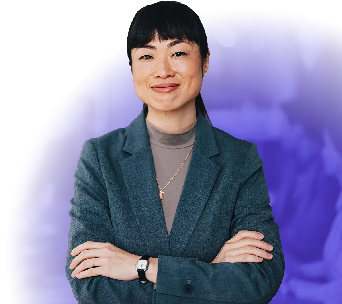 Woman in business attire with hands crossed smiling