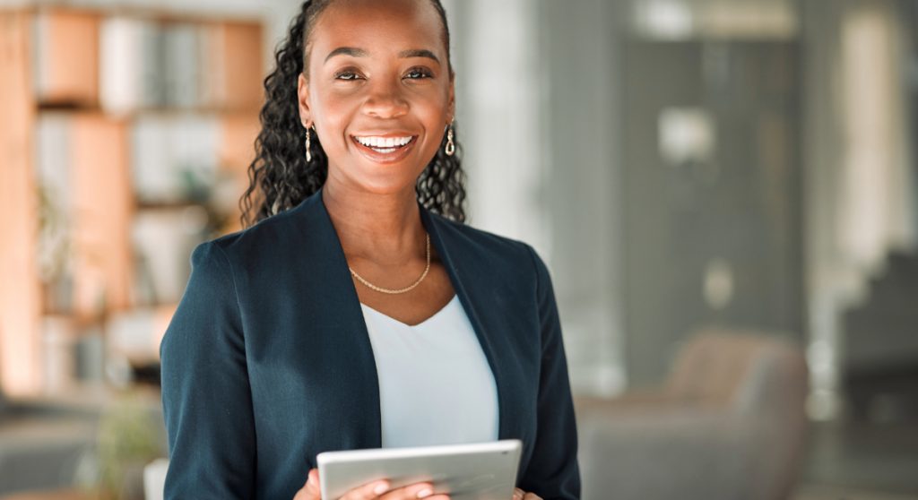Professional holding a tablet in her office