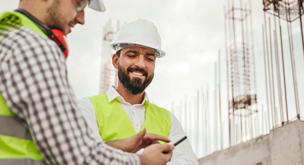 Construction workers looking at a mobile phone
