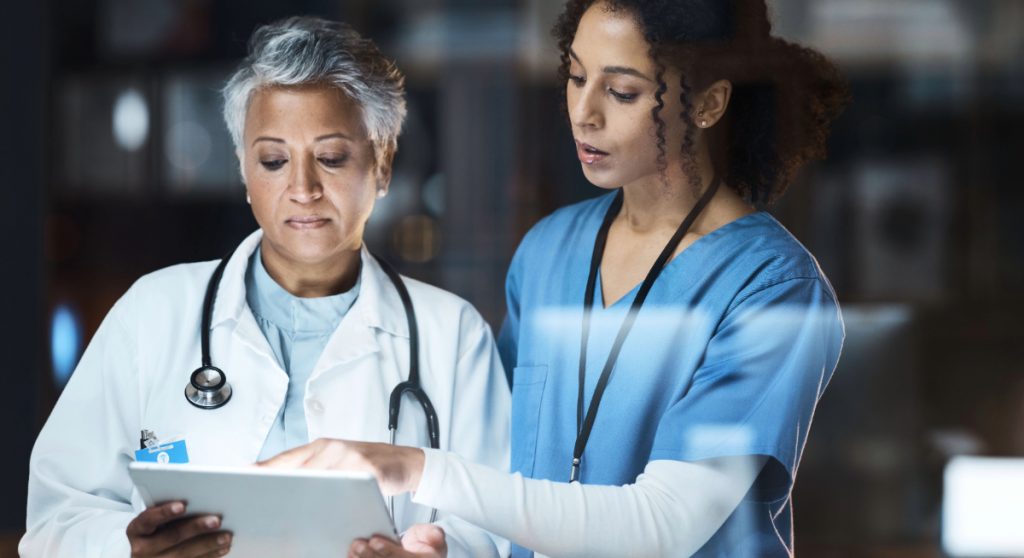 Doctor and nurse looking at tablet together