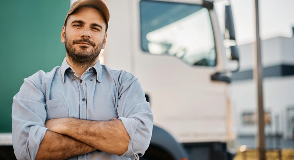 Trucker standing in front of his truck