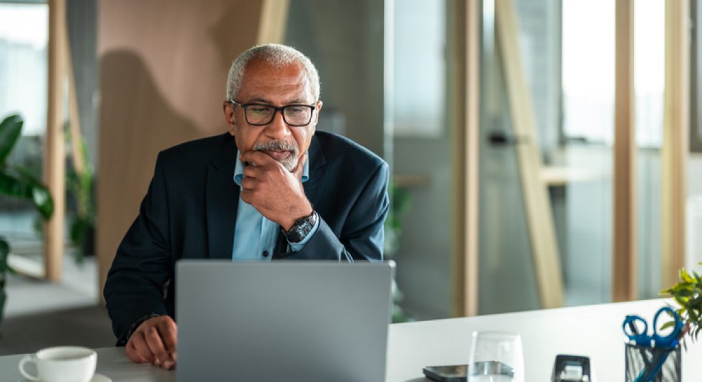 Diverse Senior Executive Ponders Business Strategy in Office