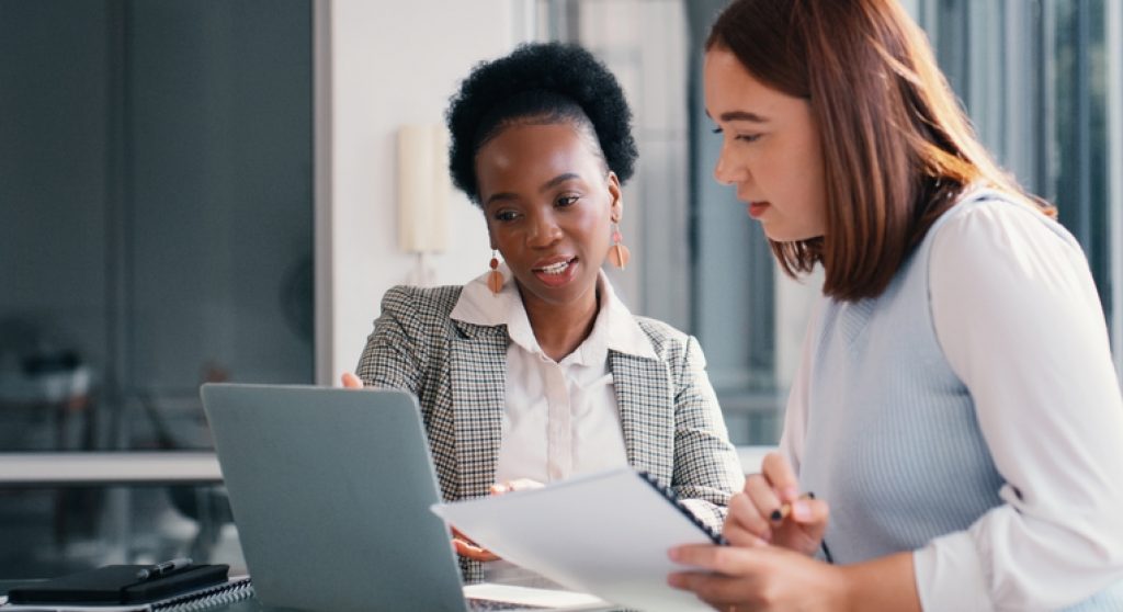 Colleagues looking at computer together