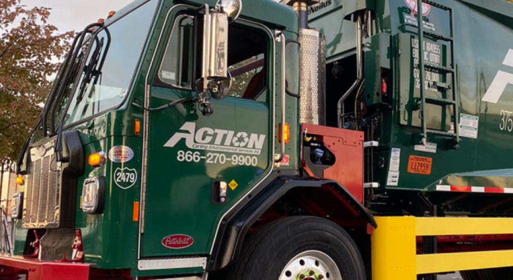 Close up of a green recycling truck