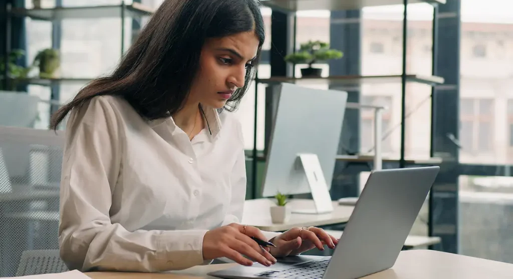 Young stressed businesswoman working on computer