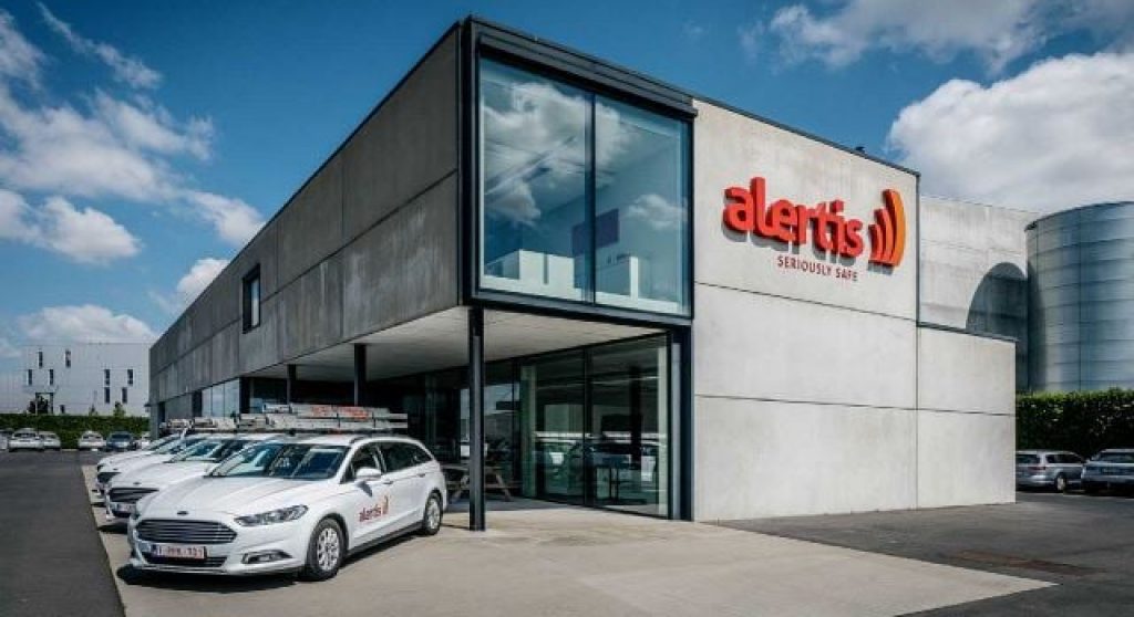 alertis building with cars sitting out front