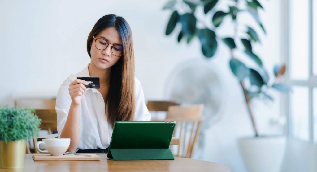 eCommerce customer on tablet looking at credit card
