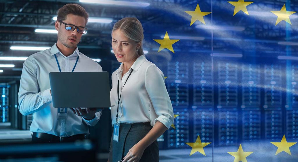 Two people working in data center with EU flag in background