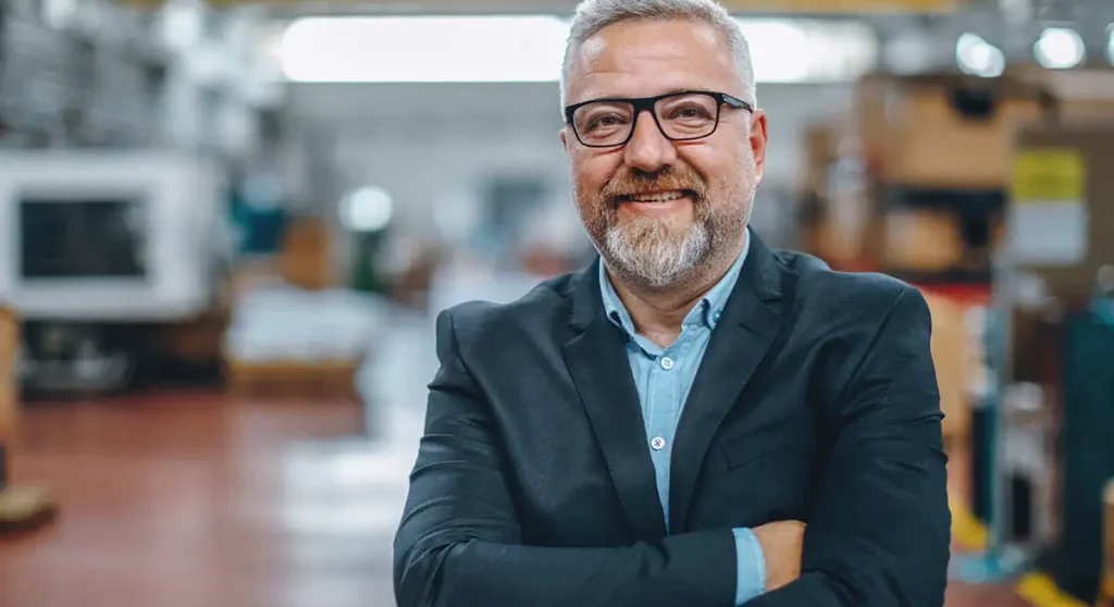 finance leader standing on a factory floor