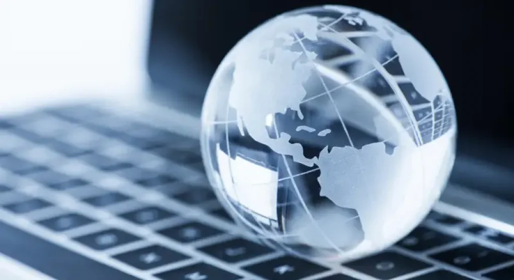 frosted glass globe sitting on laptop keyboard