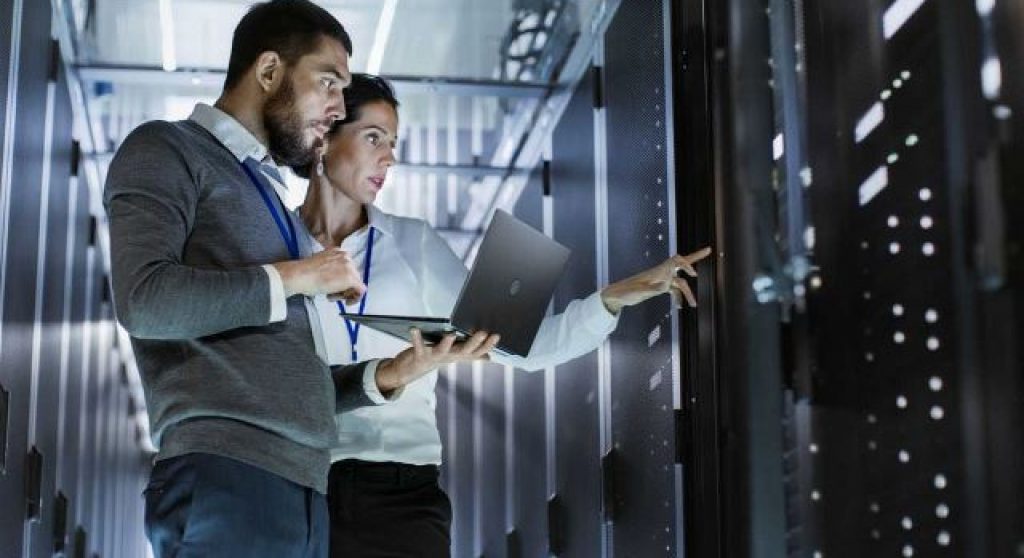 professionals looking at IT equipment