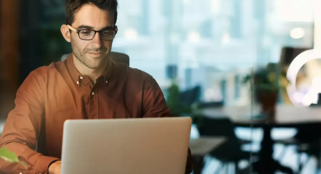 man using laptop in office
