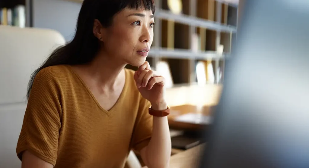 professional woman concentrating on computer monitor