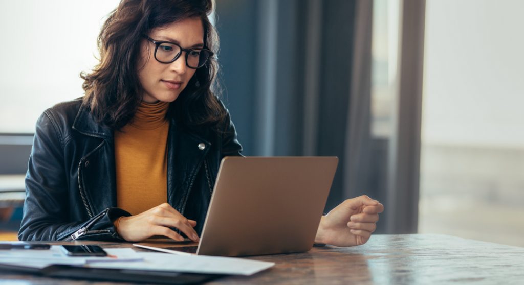 Asian woman working at laptop