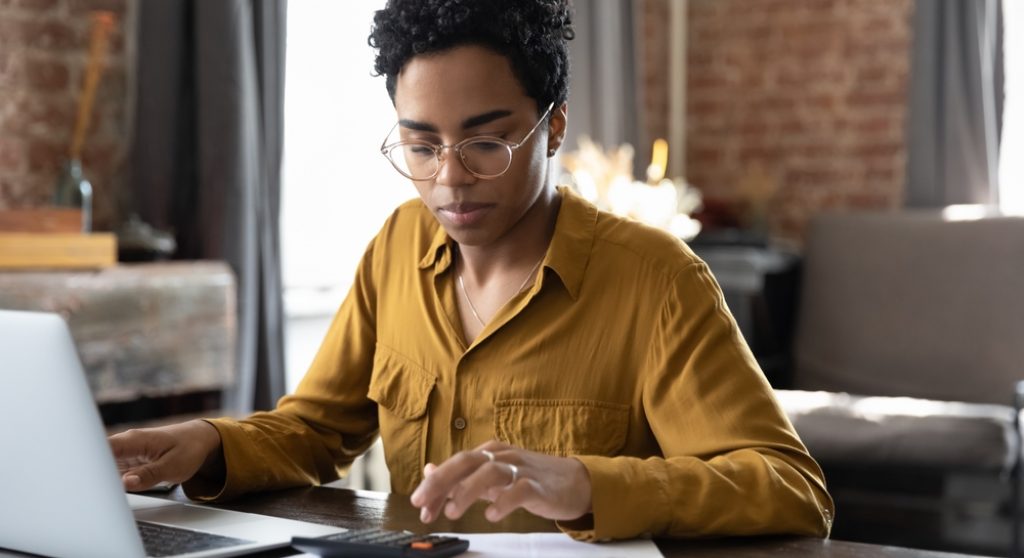 Young professional using a calculator