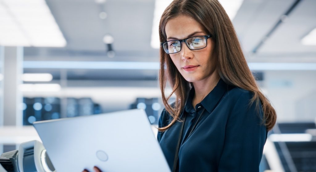 Professional woman looking at laptop