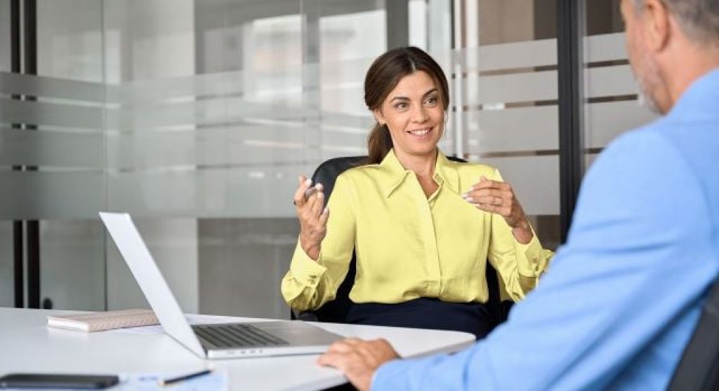 ey study featuring a woman at a conference table with a co-worker
