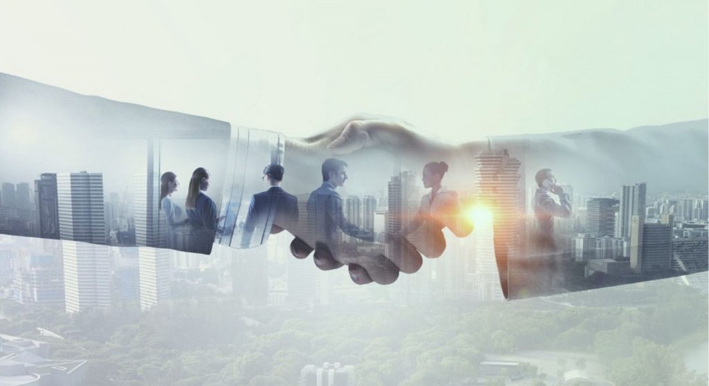 Handen schudden Afbeelding van werknemers in City Partnership tussen Deloitte Belgium en Billtrust