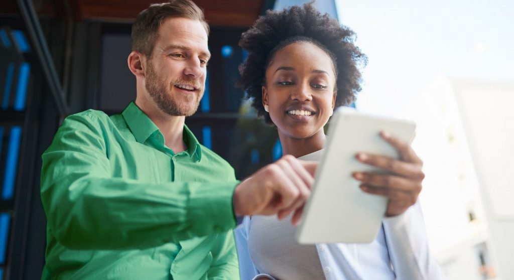 Woman and man interacting with a tablet together